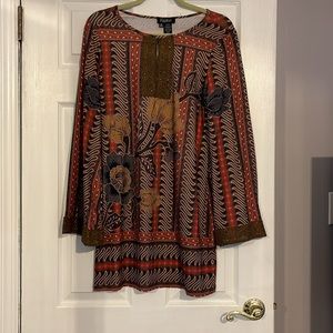 Polyester/spandex mini dress with bell flowy sleeves. Above knee length.